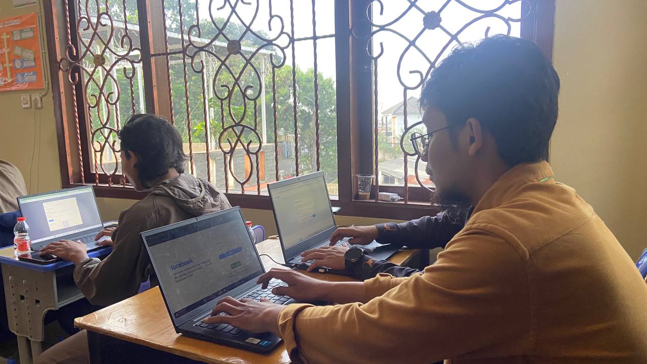 A person using laptops in front of a window AI-generated content may be incorrect.